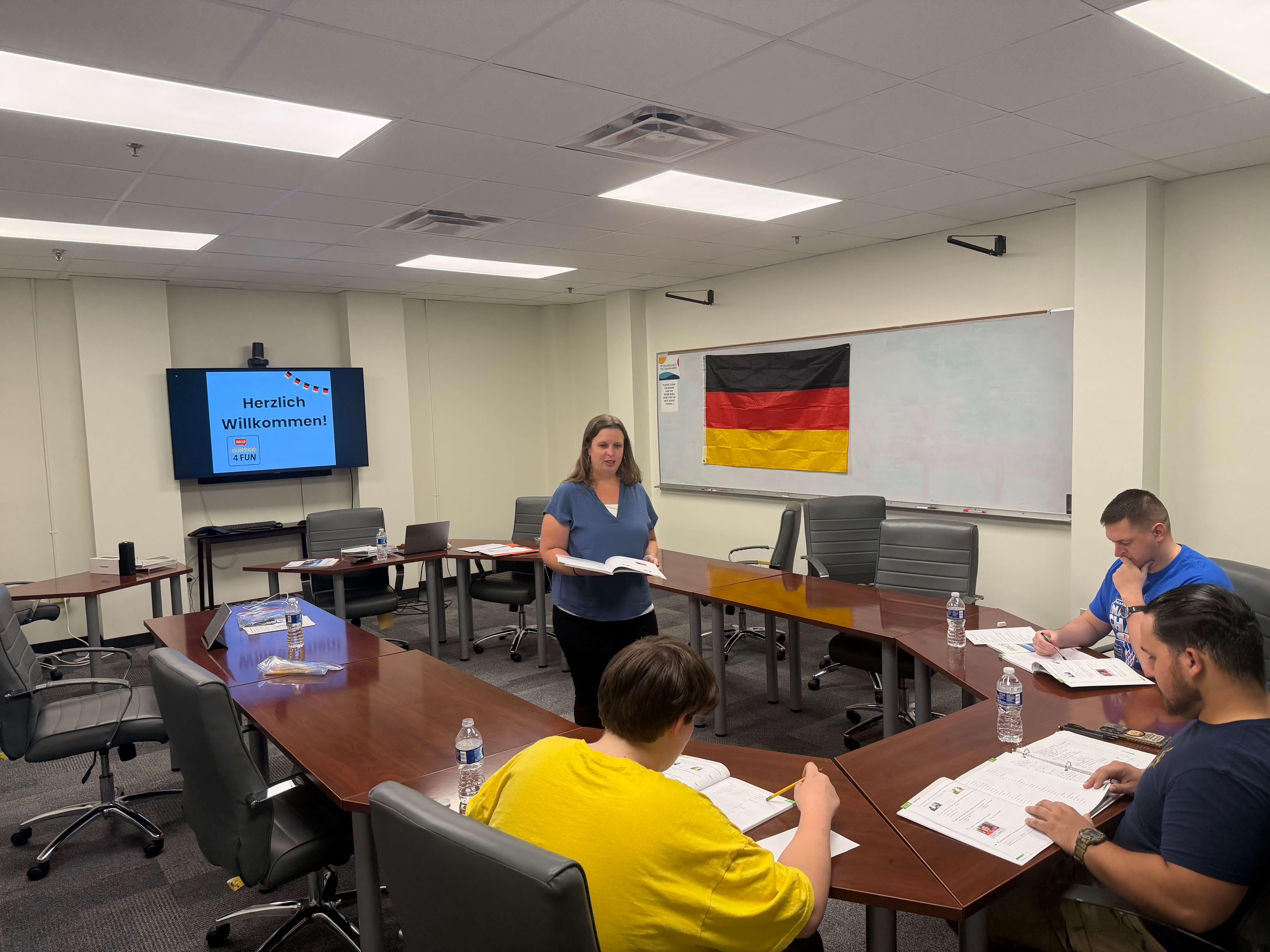 Local German class in Pensacola with students and a German flag in the room.